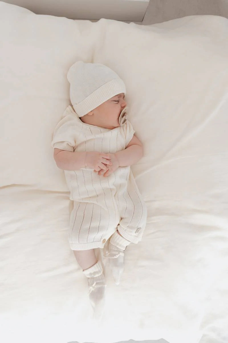 Knitted striped romper WHITE- on baby